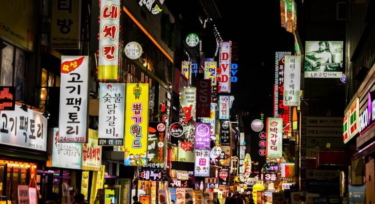 Explore Seoul's vibrant nightlife on a bustling neon-lit street lined with shops and restaurants.